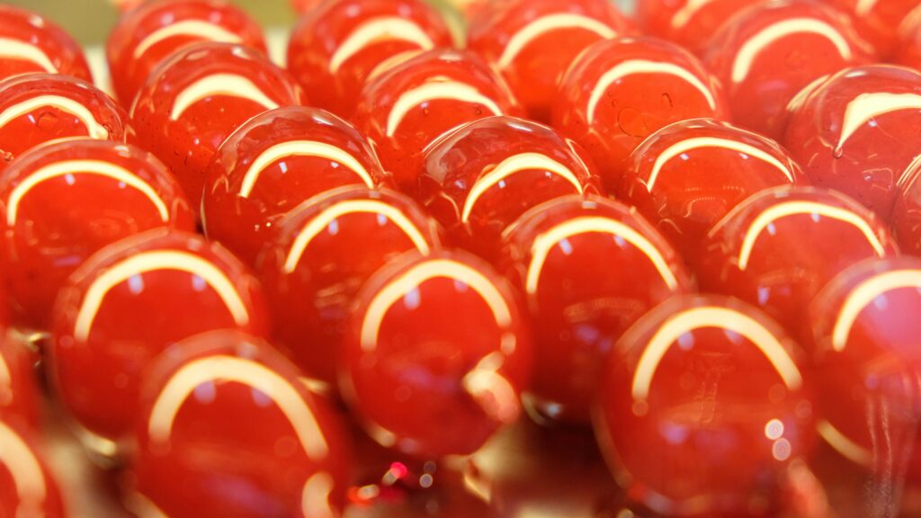 Closeup of delicious candied berries with hard sugar shell placed in row in bright light